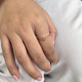 Ring with orange closed setting